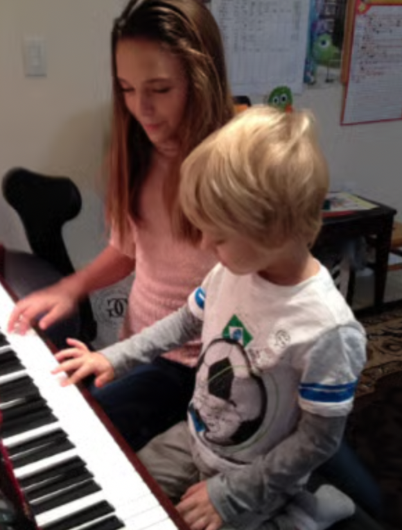 A young student learning piano